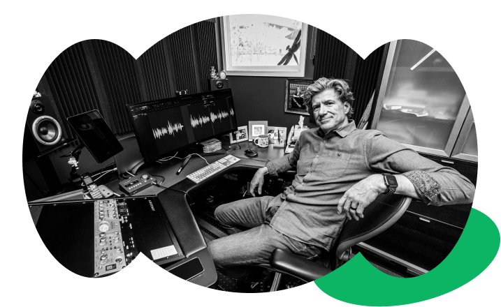 Professional narrator Paul Boucher sitting in his high-end home recording studio.